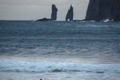 A surfer looks out at Risin and Kellingin
